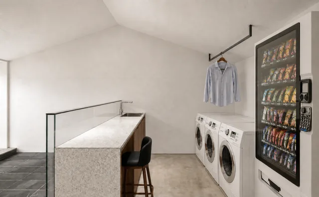 Render of the laundry area with washers and a drying island